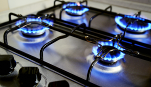 natural gas stovetop with 4 burners lit