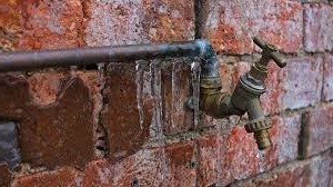 brick wall with damage from frozen water pipe